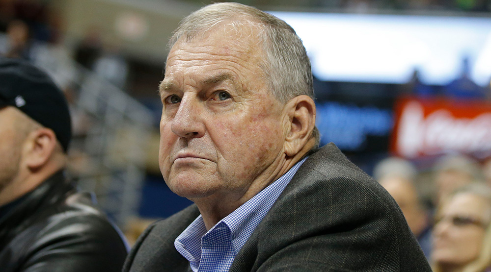 Jim Calhoun sitting on the sidelines in a coat without a tie, in a 2014 USA TODAY Sports Images photo by David Butler II