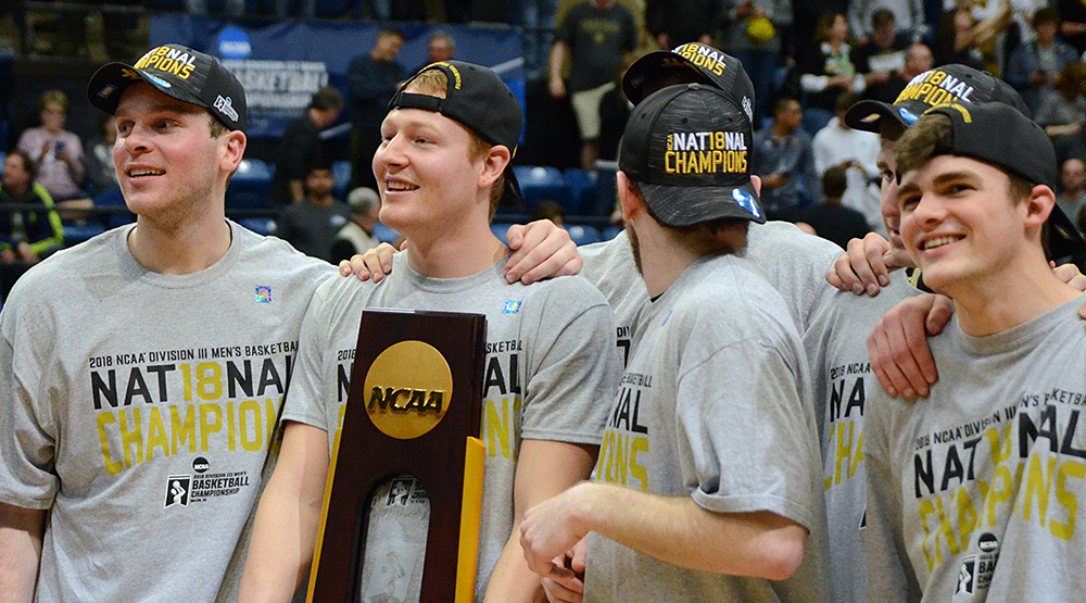 Nebraska Wesleyan players hold the Division III men's basketball national championship trophy after the Prairie Wolves' win vs. UW-Oshkosh in Salem. (Photo by Dave Hilbert, d3photography.com)