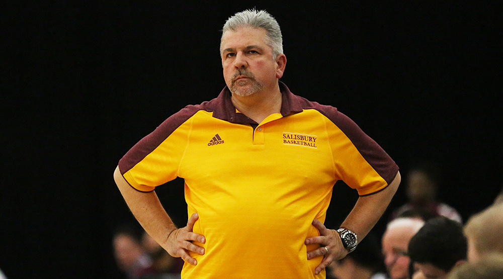 Andy Sachs stands with his hands on his hips as his team plays in Las Vegas at the 2015-16 D3hoops.com Classic. (Photo by Larry Radloff, d3photography.com)