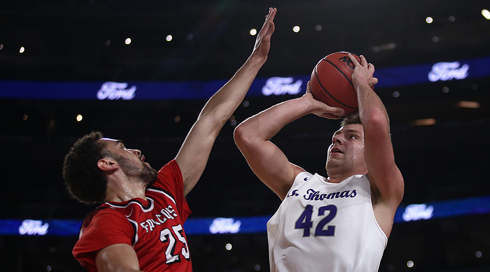 St. Thomas forward Connor Bair shoots over UW-River Falls forward Austin Jackson in the first half of the teams' contest at U.S. Bank Stadium in Minneapolis. (Photo by Ryan Coleman, d3photography.com)
