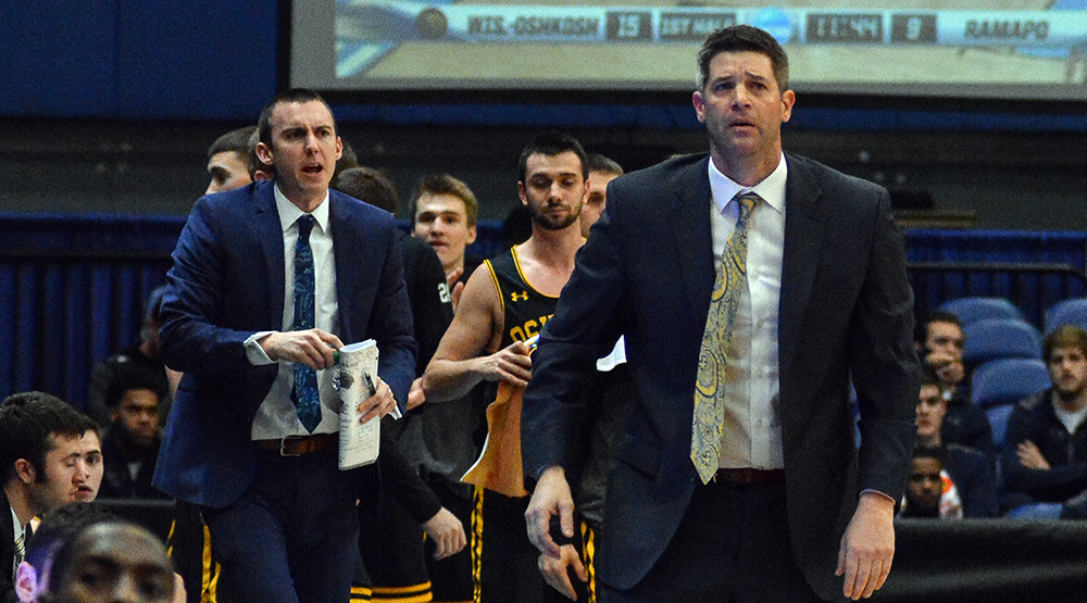 Jason Lewis, in the background, and Pat Juckem, foreground, coaching UW-Oshkosh in last year's national semifinals. (Photo by Dave Hilbert, d3photography.com)
