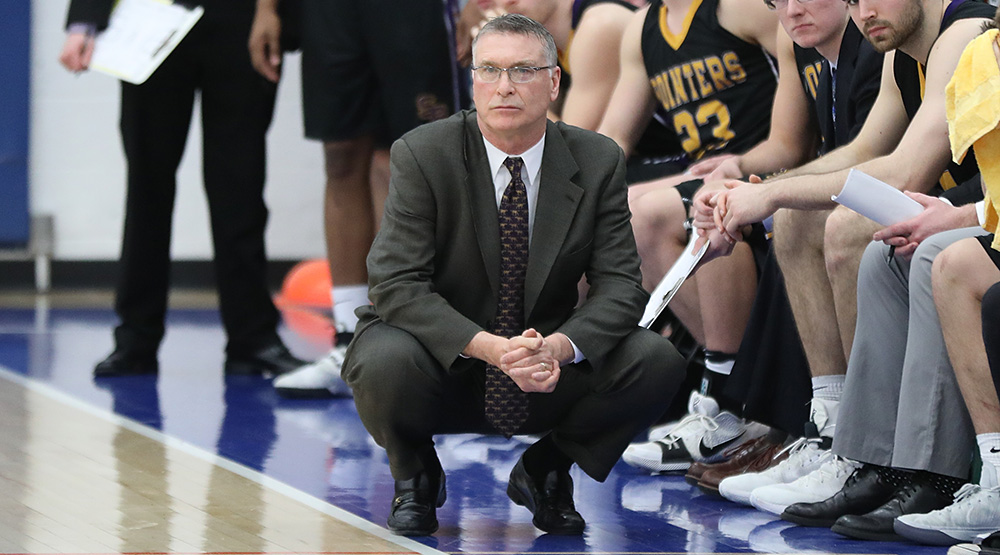 Bob Semling squats along the sidelines at a Division III NCAA Tournament game at UW-Platteville