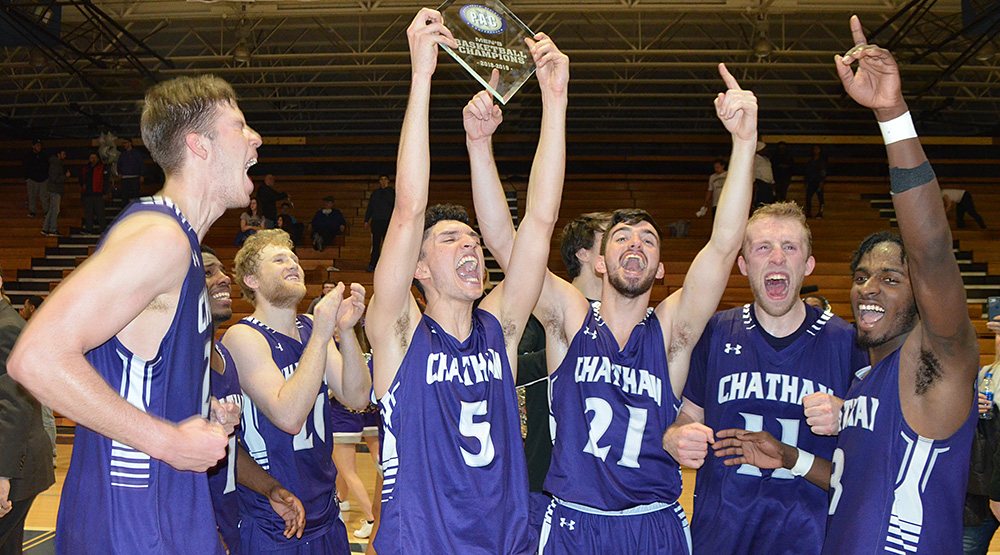 Chatham men's basketball players celebrate with the PAC trophy.