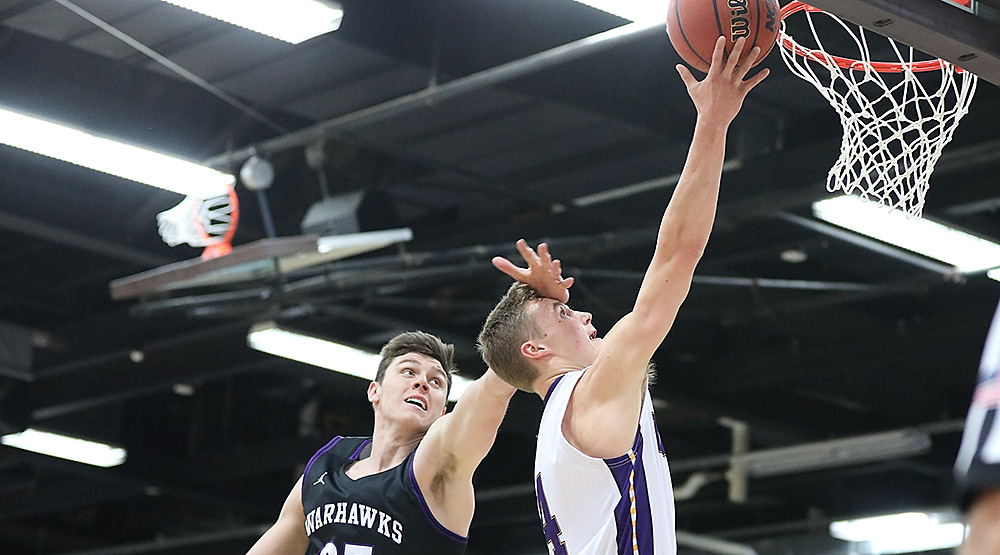 Ethan Bublitz fights through the contact on his way to the rim with two of his 12 points as No. 12 UW-Stevens Point defeated No. 10 UW-Whitewater in the teams' WIAC opener. (Photo by Steve Frommell, d3photography.com)